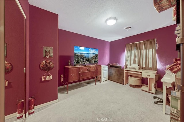 home office with baseboards, carpet, visible vents, and a textured ceiling