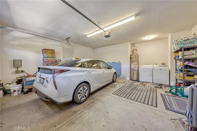 garage with a garage door opener, strapped water heater, and washer and dryer