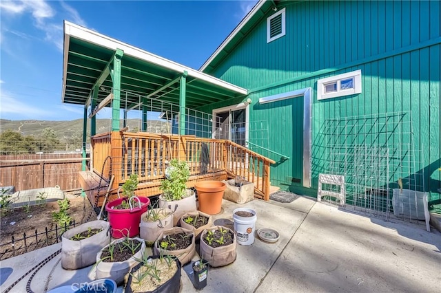 view of patio featuring fence and a mountain view