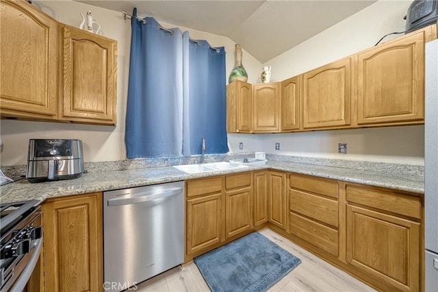 kitchen with sink, light hardwood / wood-style flooring, stainless steel appliances, light stone countertops, and vaulted ceiling