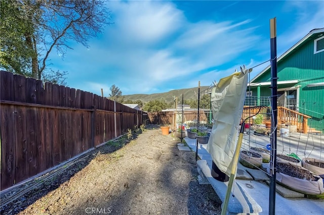 view of yard featuring a fenced backyard and a mountain view