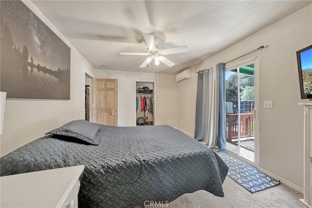 bedroom featuring carpet flooring, a wall mounted AC, access to outside, ceiling fan, and a textured ceiling