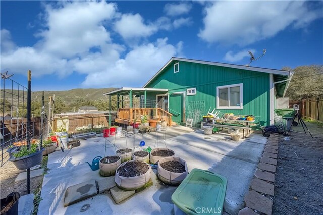 back of property featuring a patio and a mountain view