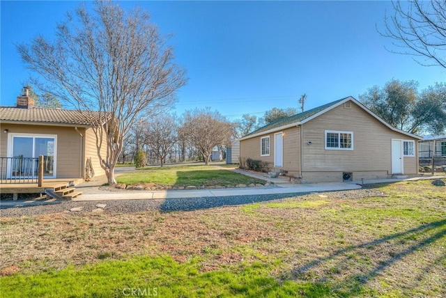 exterior space with a wooden deck and a yard