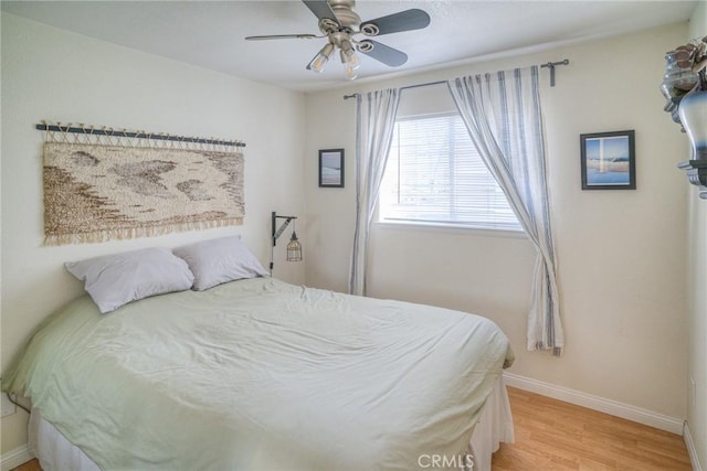 bedroom with ceiling fan and light hardwood / wood-style floors