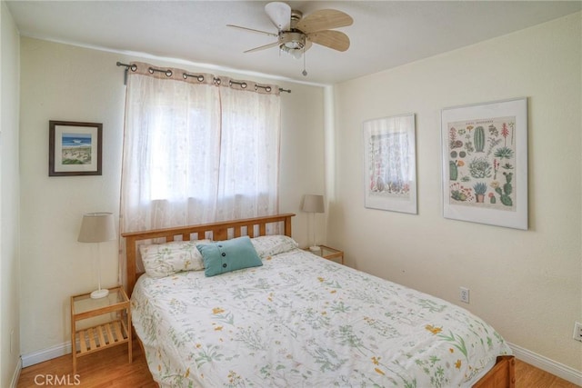 bedroom with hardwood / wood-style floors and ceiling fan