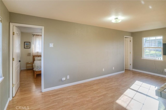 unfurnished bedroom with light wood-type flooring