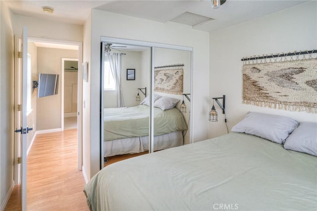 bedroom featuring wood-type flooring and a closet