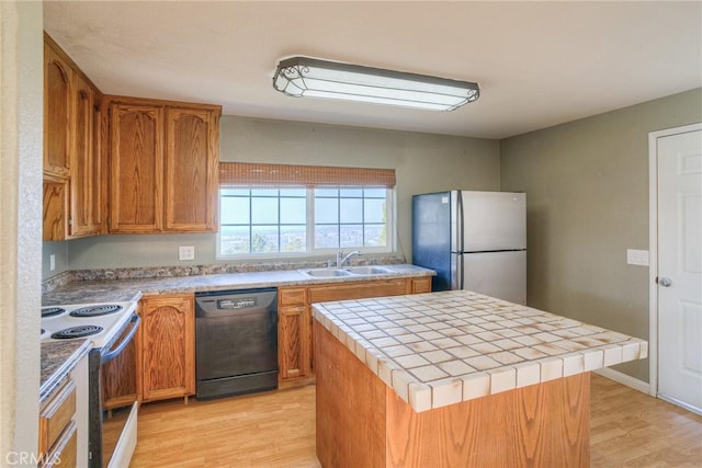 kitchen featuring sink, stainless steel fridge, dishwasher, electric range, and a kitchen island