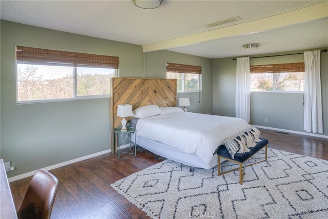 bedroom with dark hardwood / wood-style floors