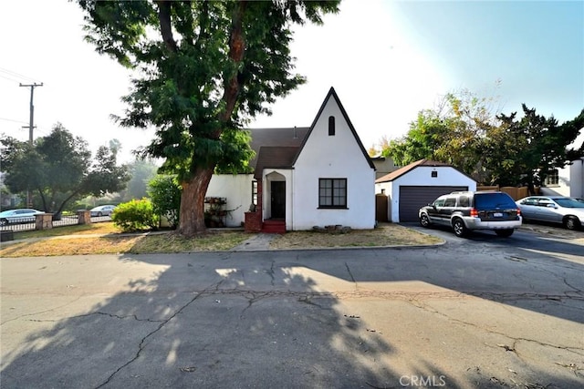 view of front of home with a garage and an outdoor structure