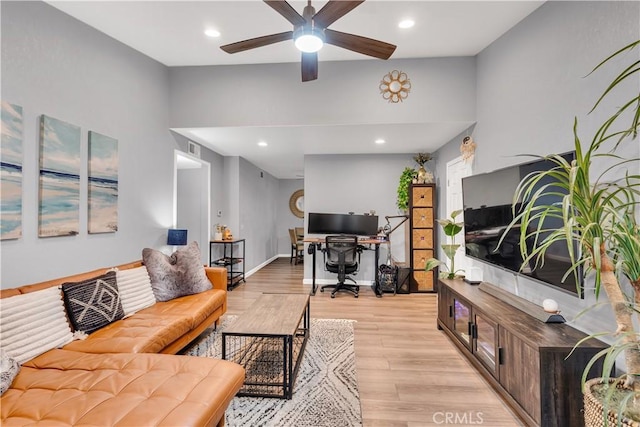 living room featuring ceiling fan and light hardwood / wood-style flooring