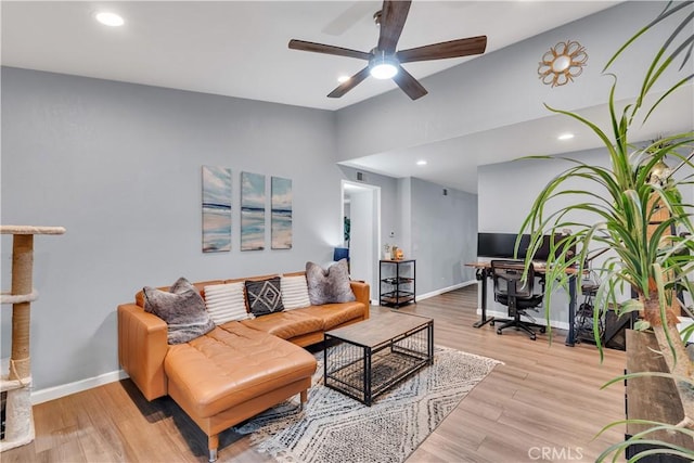 living room featuring vaulted ceiling, ceiling fan, and light wood-type flooring