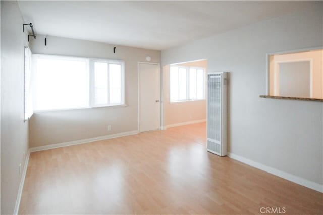 unfurnished room with light hardwood / wood-style flooring