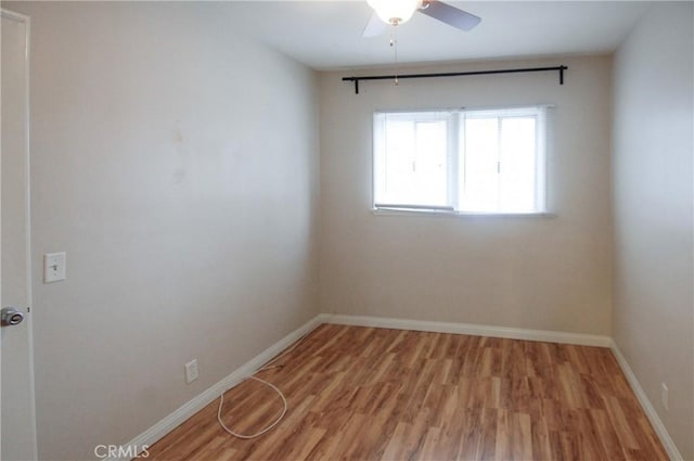 empty room with hardwood / wood-style floors and ceiling fan