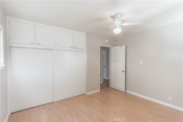 unfurnished bedroom with ceiling fan, a closet, and light hardwood / wood-style flooring