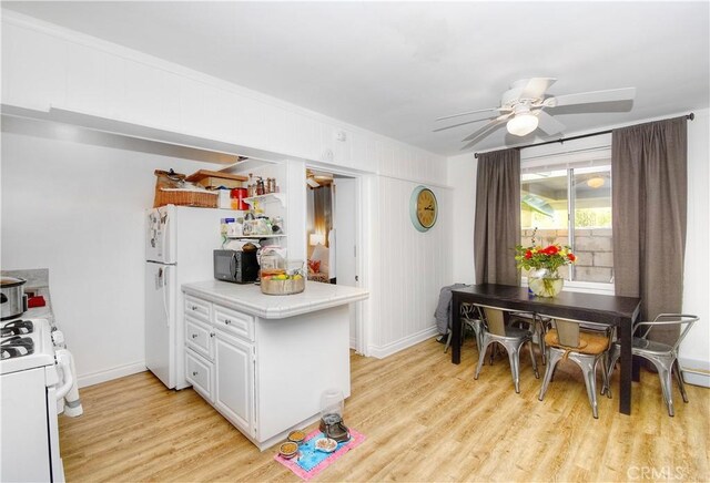 kitchen with white cabinetry, white appliances, ceiling fan, and light wood-type flooring