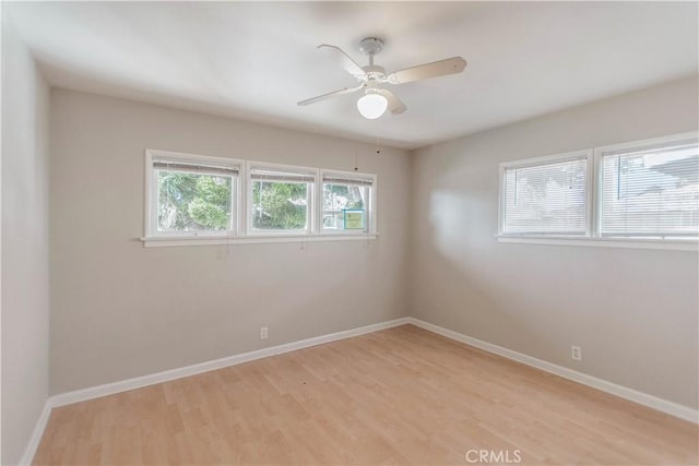 spare room featuring ceiling fan and light hardwood / wood-style floors