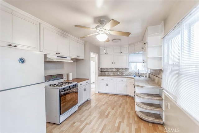 kitchen with white cabinetry, white appliances, decorative backsplash, and light hardwood / wood-style flooring