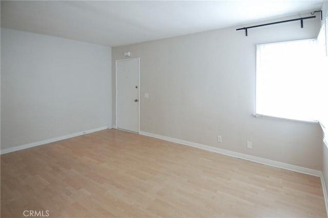 spare room with light hardwood / wood-style flooring