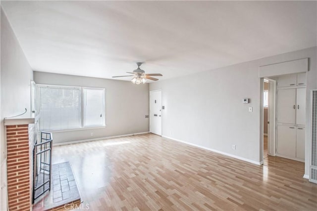 unfurnished living room featuring ceiling fan and light hardwood / wood-style flooring