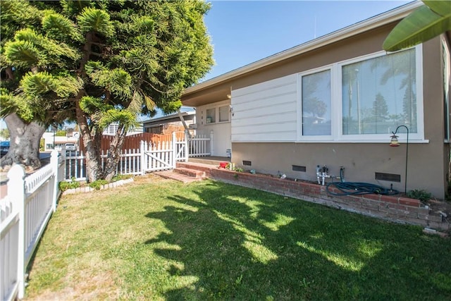 view of home's exterior with a yard