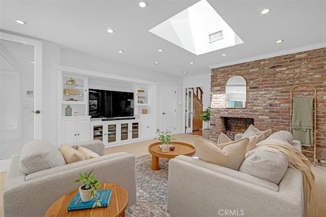 living room with a brick fireplace, a skylight, and built in features