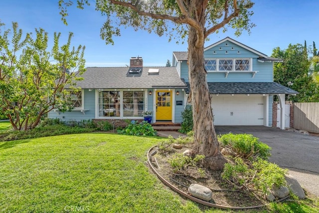 view of front of property featuring a garage and a front yard