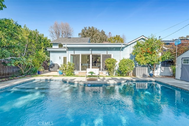 view of swimming pool featuring cooling unit and a storage unit