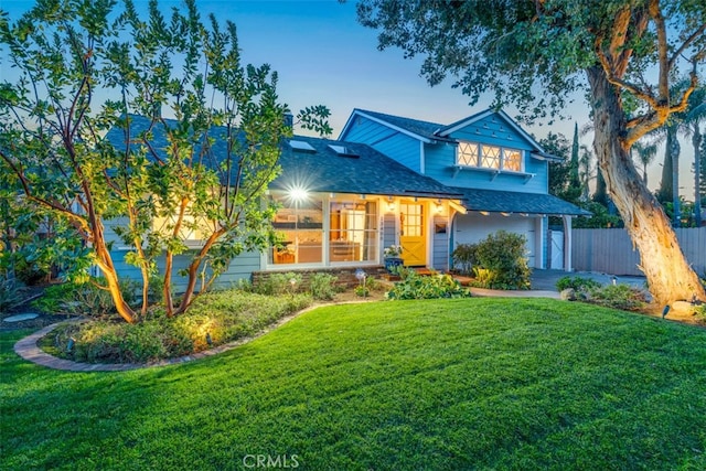 view of front of house with a garage and a front yard