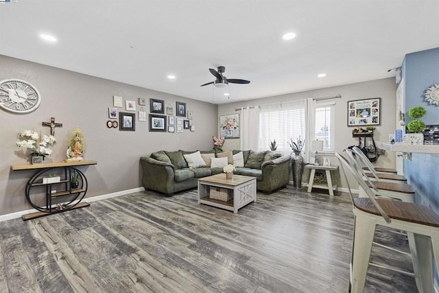 living room featuring hardwood / wood-style flooring and ceiling fan