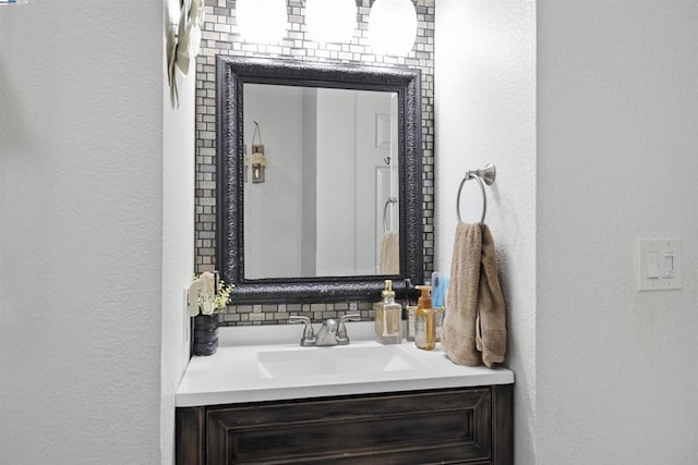 bathroom featuring vanity and decorative backsplash