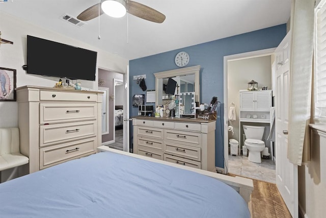 bedroom featuring ceiling fan, wood-type flooring, and connected bathroom