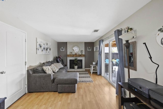 living room featuring a fireplace and light hardwood / wood-style flooring