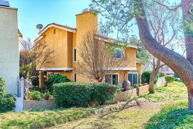 rear view of property featuring a yard