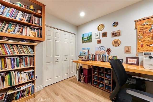 home office with light hardwood / wood-style floors