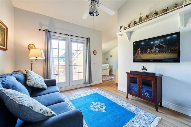 living room with hardwood / wood-style flooring, french doors, and ceiling fan