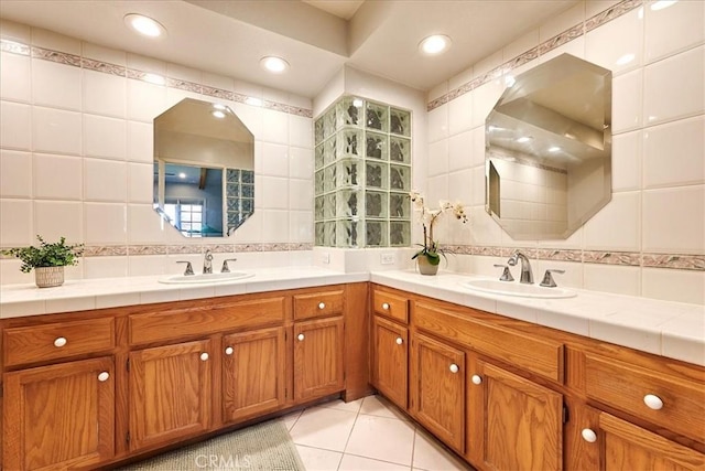 bathroom with tile patterned floors, vanity, tile walls, and backsplash