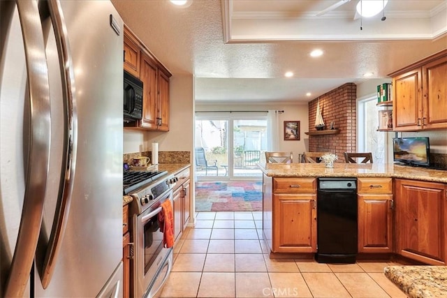 kitchen featuring light stone countertops, ornamental molding, stainless steel appliances, and kitchen peninsula