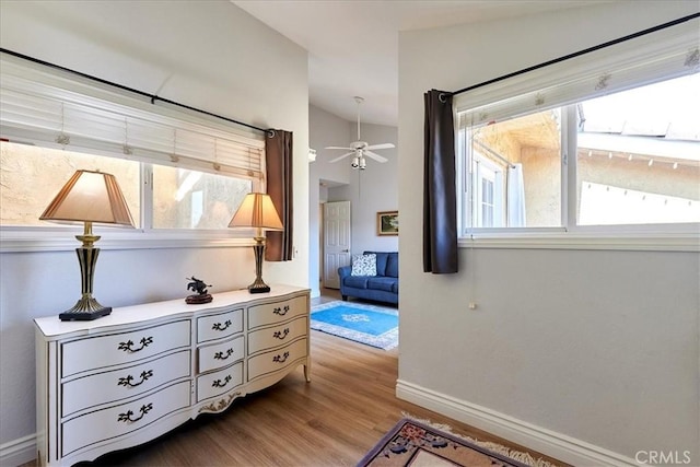 hallway featuring vaulted ceiling and light hardwood / wood-style floors