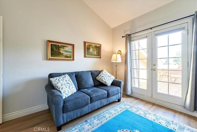 sitting room with hardwood / wood-style flooring, lofted ceiling, and french doors