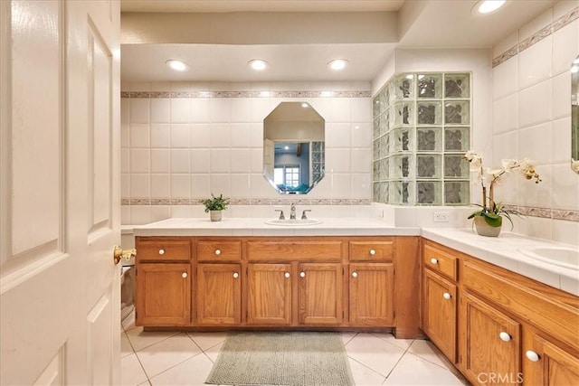 bathroom with vanity, tile patterned flooring, tile walls, and backsplash