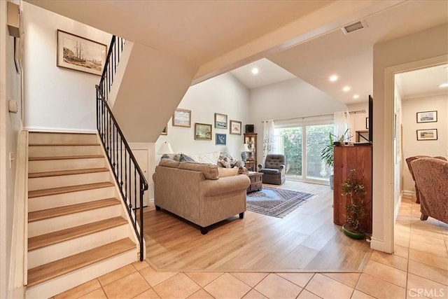 living room with vaulted ceiling and light wood-type flooring