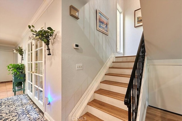 stairway with hardwood / wood-style flooring and ornamental molding