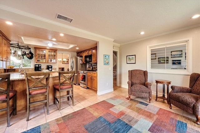 tiled living room with ornamental molding, a raised ceiling, and indoor wet bar