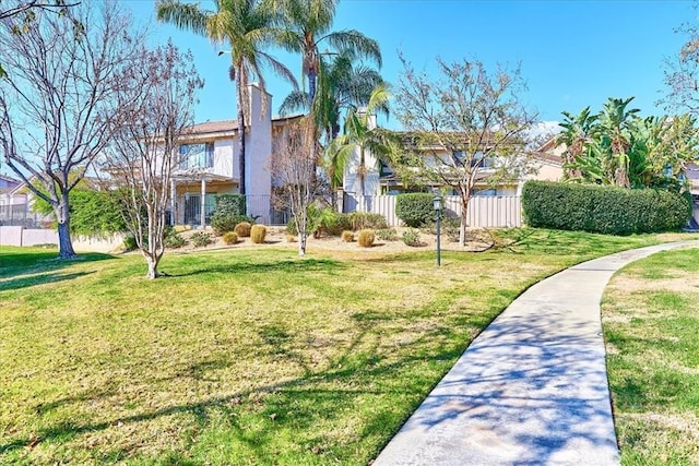 view of home's community with a lawn