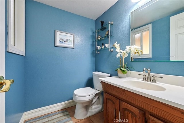 bathroom with vanity, tile patterned floors, and toilet