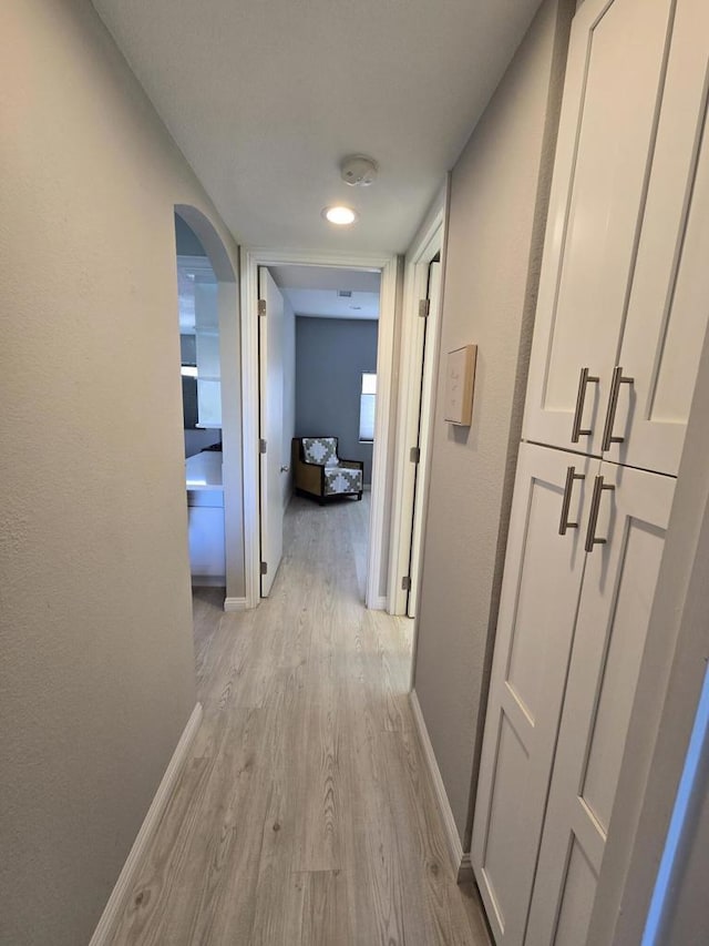 corridor with light hardwood / wood-style flooring