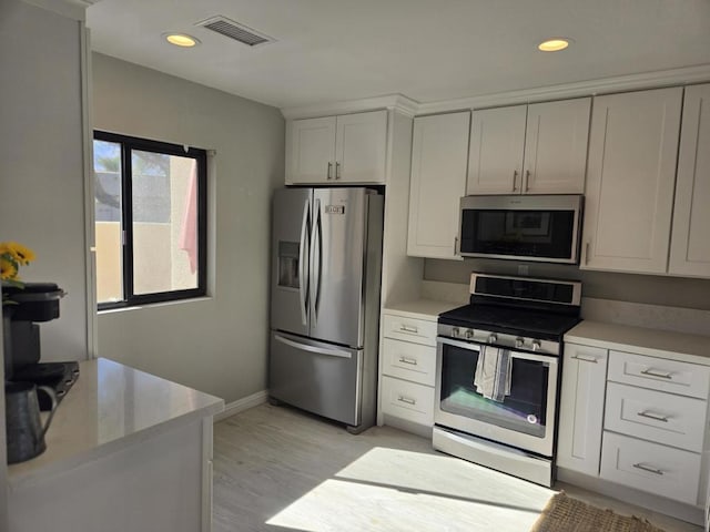 kitchen featuring white cabinetry, stainless steel appliances, and light hardwood / wood-style floors