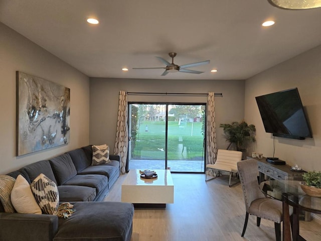 living room with ceiling fan and light hardwood / wood-style floors